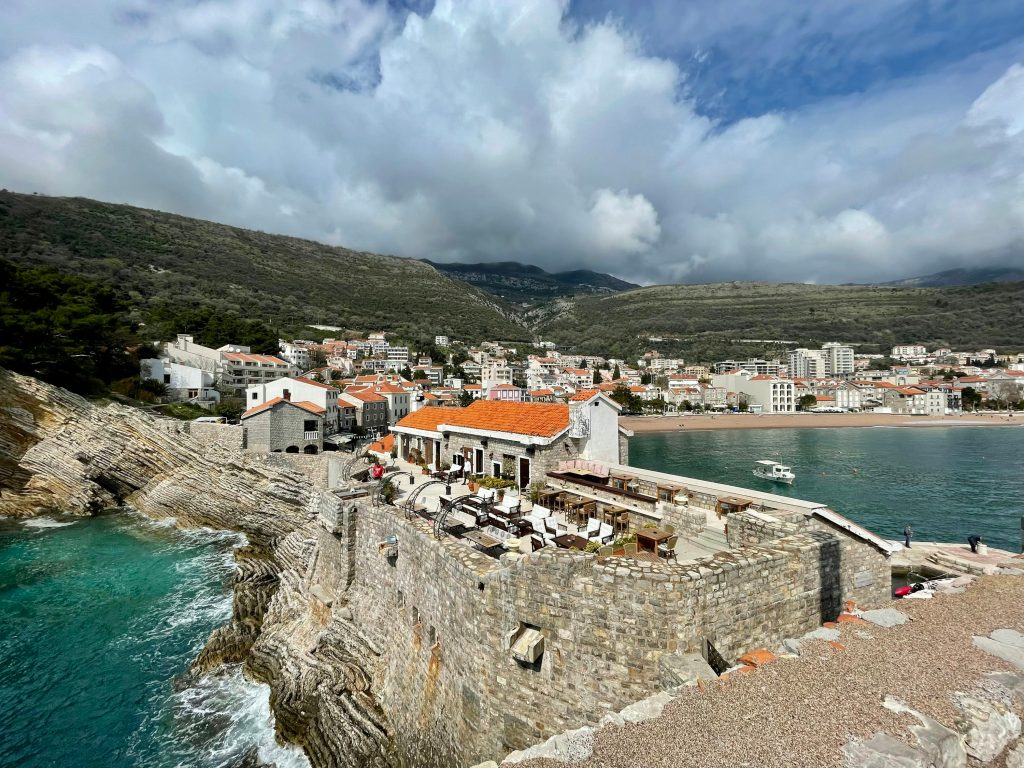 a view of a small town next to a body of water