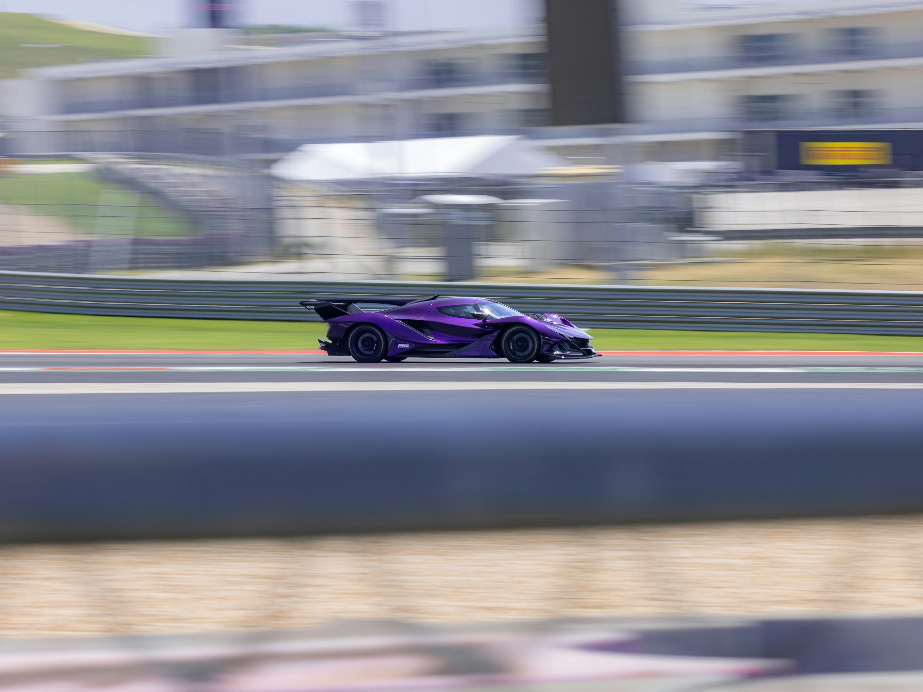 A purple race car driving down a track